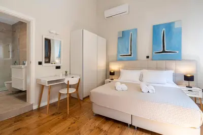 a bedroom with a bed and a desk and a sink at Letty's House - Old Town Luxury Mansion in Rhodes Town