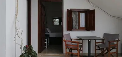 a dining room with a table and chairs and a window at Eleftheria Lindian Studios II in Líndos