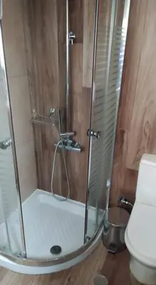 a shower with a glass door in a bathroom at Niochori apartments 1 in Rhodes Town