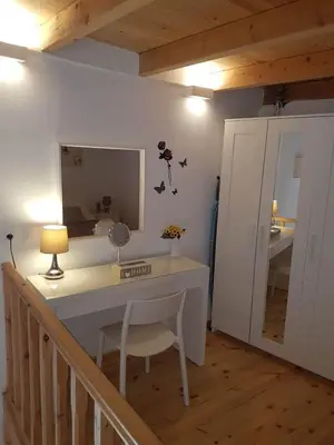 a room with a desk with a mirror and a chair at Niochori apartments 1 in Rhodes Town