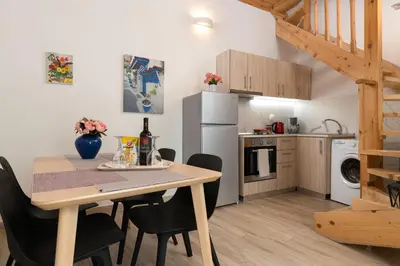 a kitchen and dining room with a table and chairs at Niochori apartments 2 in Rhodes Town