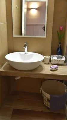 a bathroom with a white sink and a mirror at Niochori apartments 2 in Rhodes Town