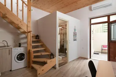 a room with a staircase and a washing machine at Niochori apartments 2 in Rhodes Town