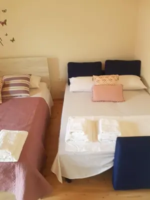 two beds sitting next to each other in a room at Niochori apartments 2 in Rhodes Town