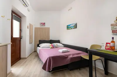 a small room with a bed and a table at Niochori apartments 3 in Rhodes Town