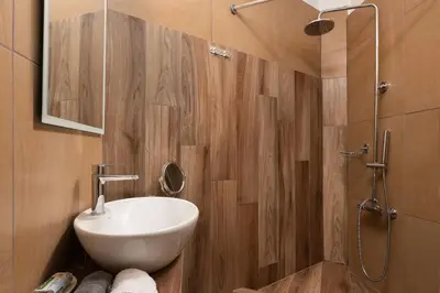a bathroom with a white sink and a shower at Niochori apartments 3 in Rhodes Town