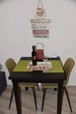 a table with two chairs and a bottle of wine at Niochori apartments 3 in Rhodes Town