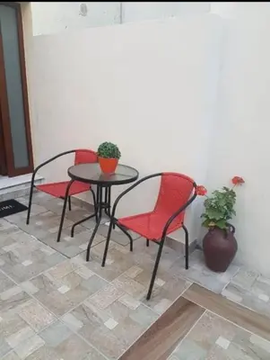 a table and two chairs and a table with a plant at Niochori apartments 3 in Rhodes Town