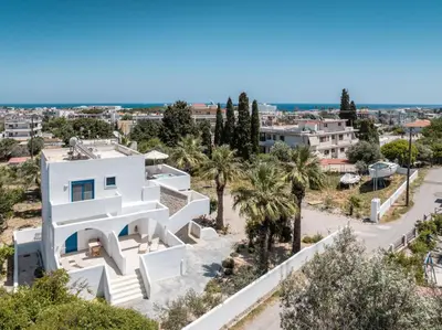 a white house with a view of a city at Studios Maria Christina in Faliraki