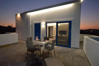 a dining room with a table and chairs on a balcony at Studios Maria Christina in Faliraki