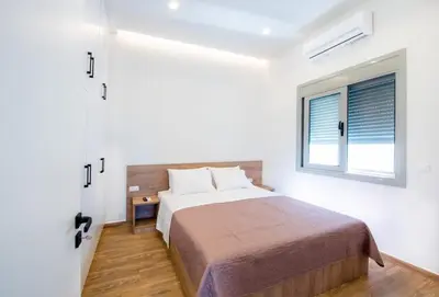 a bedroom with a bed and a window at Dias Luxury Homes in Koskinou