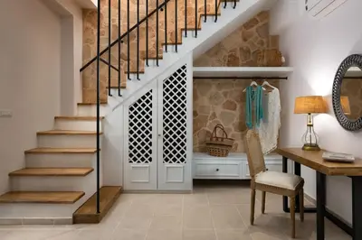 a home office with a staircase and a desk with a chair at Legato House in Rhodes Town