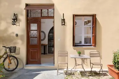 a table and chairs in front of a door at Legato House in Rhodes Town