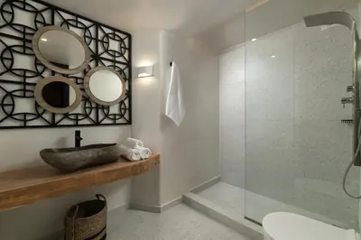 a bathroom with a shower and a sink and mirror at Legato House in Rhodes Town