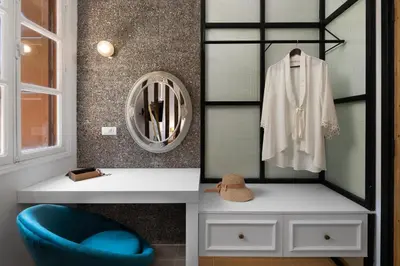 a dressing room with a mirror and a blue chair at Legato House in Rhodes Town