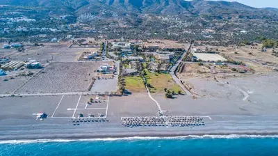 an aerial view of a parking lot next to the ocean at Kalathos Sea View House in Kalathos