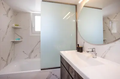 a bathroom with a sink and a mirror at Kalathos Sea View House in Kalathos