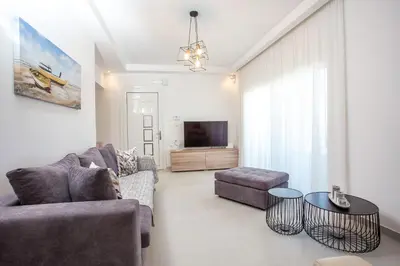 a living room with a couch and a table at Kalathos Sea View House in Kalathos