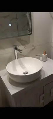 a white sink on a counter in a bathroom at Sea Breeze 2 in Haraki