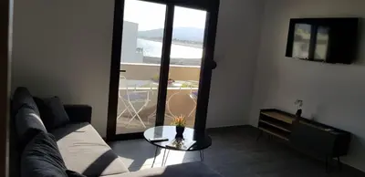 a living room with a couch and a table at Sea Breeze 2 in Haraki