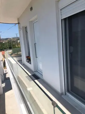 a balcony with sliding glass doors on a building at Oliva in Faliraki