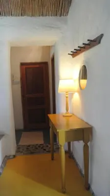 a lamp on a table in a room with a door at Exclusive apartment in Ecovilla on the beach in Apolakkiá