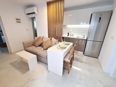 a living room with a couch and a table at Monte Smith City Home in Rhodes Town