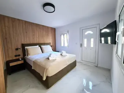 a bedroom with a bed and a window and a door at Monte Smith City Home in Rhodes Town