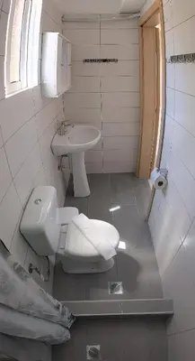 a bathroom with a toilet and a sink at Artemis Studios - Pool and garden in Koskinou