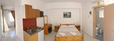 a small room with a bed and a sink at Artemis Studios - Pool and garden in Koskinou