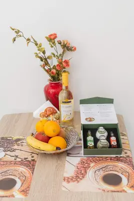 a table with a plate of fruit and a bottle of wine at AS ALESIAS SUITES.Room 12. in Rhodes Town