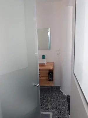 a door leading to a bathroom with a sink at AS ALESIAS SUITES.Room 12. in Rhodes Town