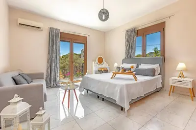 a bedroom with a bed and a couch at Prestige Residence Rhodes in Ialyssos