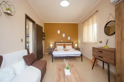 a living room with a bed and a couch at Electi Apartments Charaki in Haraki