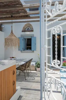 a patio with a table and chairs on a house at Antigone Traditional House in Koskinou