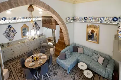 a living room with a couch and a table at Antigone Traditional House in Koskinou