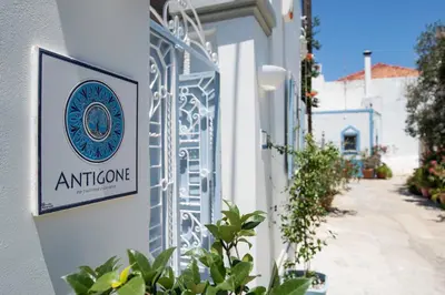 a sign on the side of a building at Antigone Traditional House in Koskinou