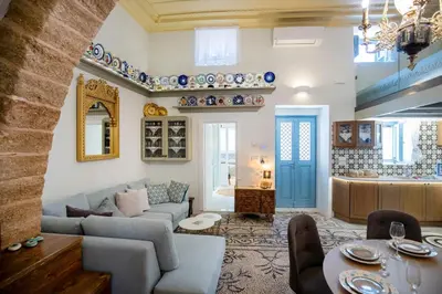 a living room with a couch and a table at Antigone Traditional House in Koskinou