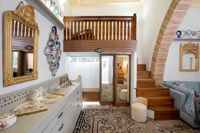 a bathroom with a sink and a mirror and a staircase at Antigone Traditional House in Koskinou
