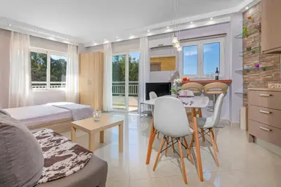 a living room with a kitchen and a dining room at 4. Sea view luxury suite for 4 in Rhodes centre! in Rhodes Town