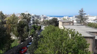 a view of a city with trees and buildings at 4. Sea view luxury suite for 4 in Rhodes centre! in Rhodes Town