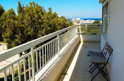 a balcony with a chair and a view of the ocean at 4. Sea view luxury suite for 4 in Rhodes centre! in Rhodes Town