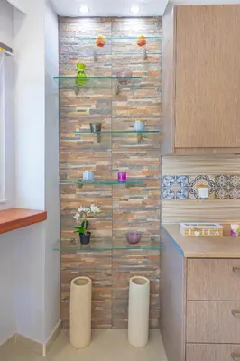 a kitchen with a wooden wall with glass shelves at 4. Sea view luxury suite for 4 in Rhodes centre! in Rhodes Town