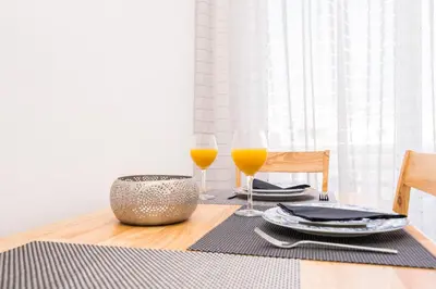 a table with two glasses of orange juice on it at Studio Amarantios in Rhodes Town