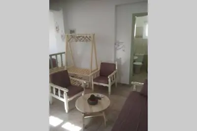 a living room with two chairs and a table at STUDIO ASTERO in Pefki Rhodes