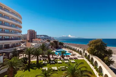 a view of a resort with a pool and a beach at Cactus Hotel in Rhodes Town