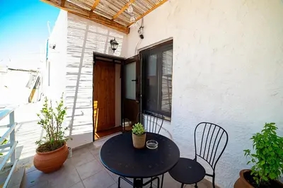 a patio with a table and chairs on a balcony at Natasha's Nest in Rhodes Town