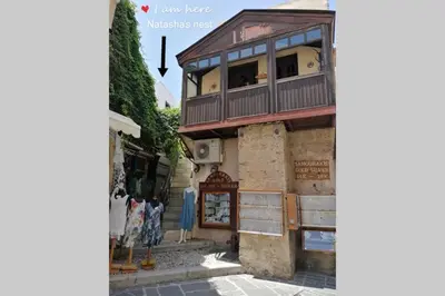 a building with a balcony on the side of a street at Natasha's Nest in Rhodes Town