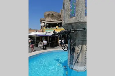 a water fountain in the side of a building at Natasha's Nest in Rhodes Town