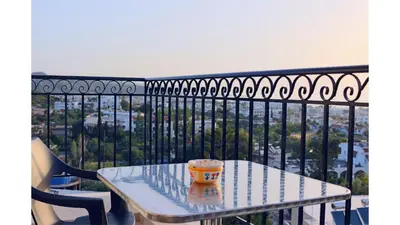 a coffee cup sitting on a table on a balcony at Planet View in Faliraki